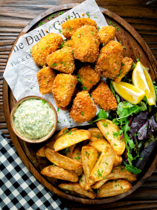 Overhead fish goujons or nuggets made with monkfish served with tartar sauce and wedges.