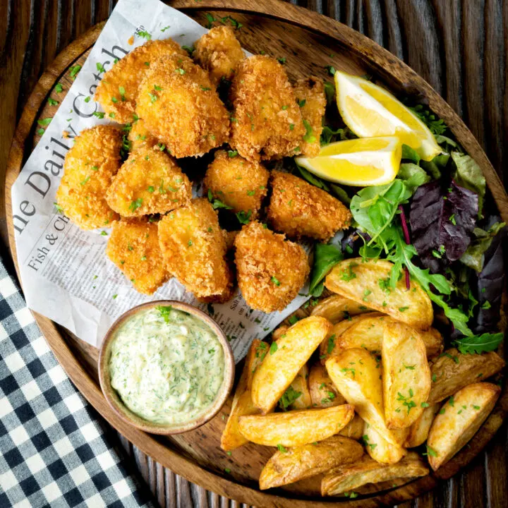 Fish goujons or nuggets made with monkfish served with tartar sauce and air fryer wedges.
