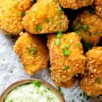 Close-up overhead fish goujons or nuggets made with monkfish served with tartar sauce.