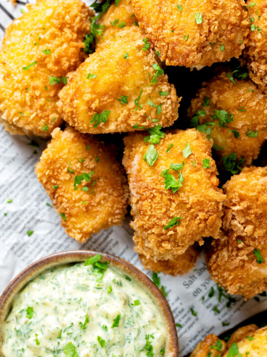 Close-up overhead fish goujons or nuggets made with monkfish served with tartar sauce.