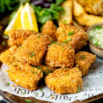 Fish goujons or nuggets made with monkfish served with tartar sauce and wedges.
