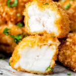 Fish goujons or nuggets with one cut open showing the meaty texture of monkfish.