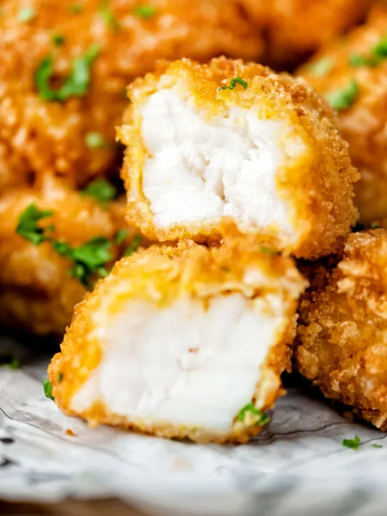 Fish goujons or nuggets with one cut open showing the meaty texture of monkfish.