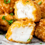 Fish goujons or nuggets with one cut open showing the meaty texture of monkfish featuring a title overlay.
