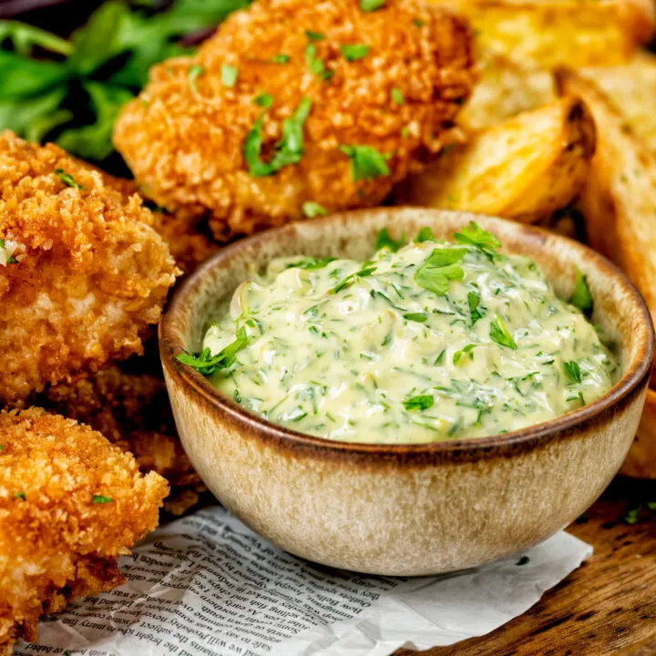 Close up homemade tartar sauce served with fish goujons.