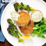 Overhead fish cakes served with homemade tartar sauce featuring a title overlay.