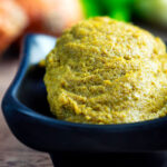 Spoonful of homemade Thai green curry paste.
