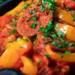 Close-up Hungarian pepper and tomato stew known as lecsó or lecso featuring a title overlay.