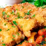 Close-up kotlet schabowy (Polish pork schnitzel) served with lecso.