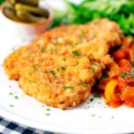 Kotlet schabowy (Polish pork schnitzel) served with lecso and pickles.