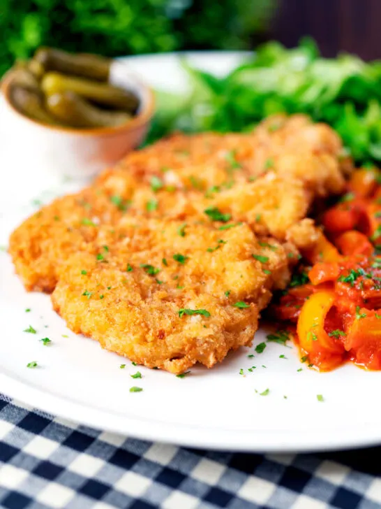 Kotlet schabowy (Polish pork schnitzel) served with lecso and pickles.