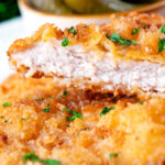 Close-up kotlet schabowy cut open to show the juicy tender pork meat.