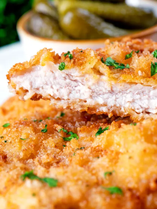 Close-up kotlet schabowy cut open to show the juicy tender pork meat.