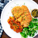 Overhead kotlet schabowy (Polish pork schnitzel) with lecso.