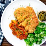 Overhead kotlet schabowy (Polish pork schnitzel) with lecso.