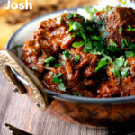 Lamb rogan josh curry with rice, naan and fresh coriander featuring a title overlay.