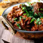 Lamb rogan josh curry with rice, naan and fresh coriander featuring a title overlay.