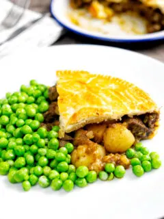 Traditional meat and potato pie served with garden peas.