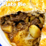 Close up of a meat and potato plate pie showing the filling featuring a title overlay.