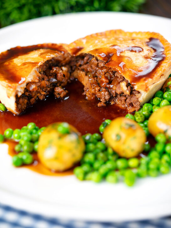 Homemade minced beef and onion pie cut open showing the filling.