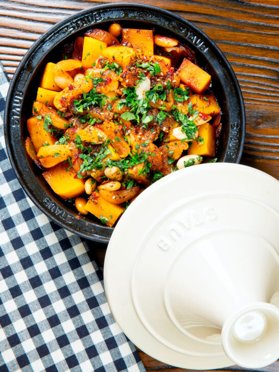 Overhead butternut squash tagine served in a tagine pot.