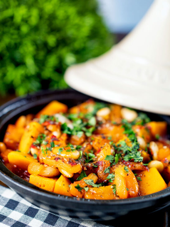 Close-up butternut squash tagine served in a tagine pot featuring a title overlay.