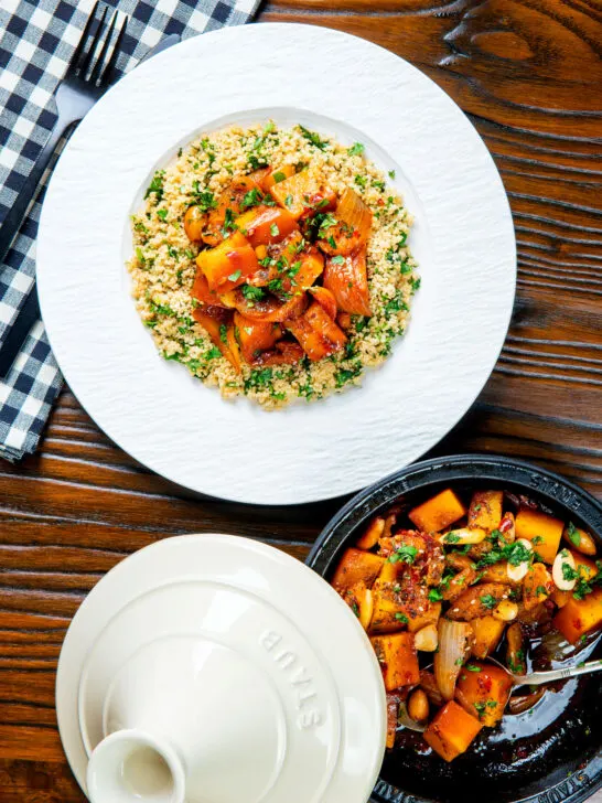 Overhead butternut squash tagine served with buttered herby couscous.