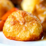 Close-up crispy on the outside fluffy on the inside perfect Sunday lunch roast potatoes.