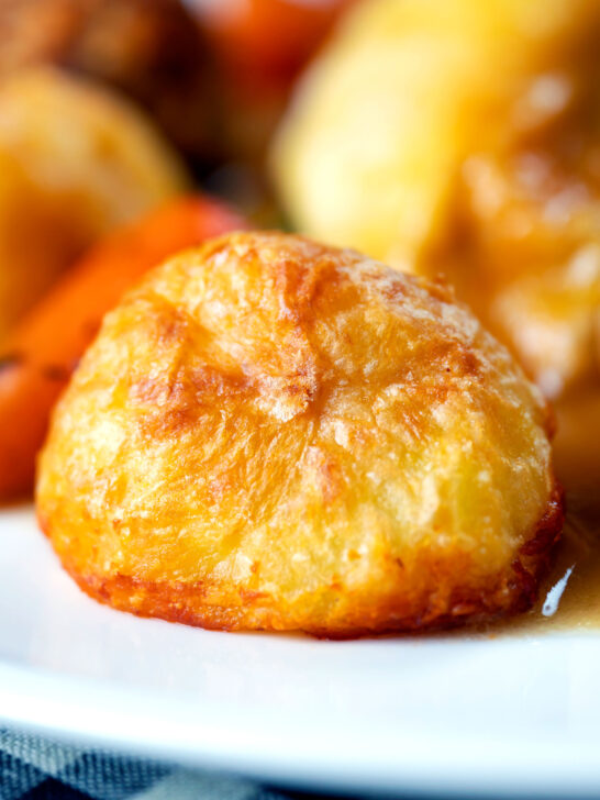 Close-up crispy on the outside fluffy on the inside perfect Sunday lunch roast potatoes.