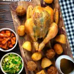 Overhead perfect Sunday roast chicken with roast potatoes, stuffing balls, veggies and gravy featuring a title overlay.