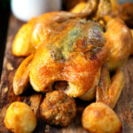 Perfect Sunday roast chicken with roast potatoes and Sage and onion stuffing balls.