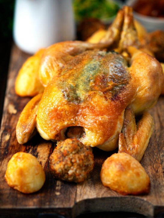 Perfect Sunday roast chicken with roast potatoes and Sage and onion stuffing balls.