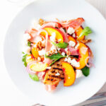 Overhead pickled peach, rocket (arugula), goat cheese and Parma ham salad.