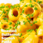 Close-up roasted butternut squash pasta garnished with snipped chives featuring a title overlay.