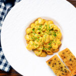Overhead roasted butternut squash pasta served with garlic bread.