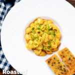 Overhead roasted butternut squash pasta served with garlic bread featuring a title overlay.