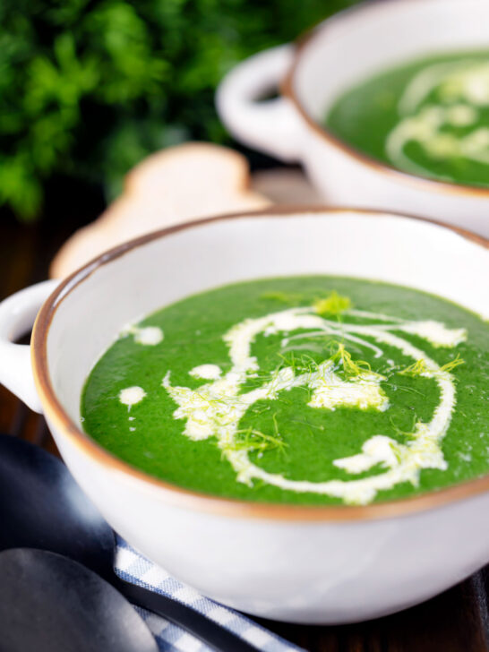 Spinach and fennel soup with fresh fennel fronds and bread.