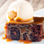 Sticky toffee pudding served with caramel sauce and vanilla ice cream.
