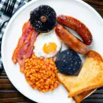 Overhead full English breakfast or the ultimate fry up featuring a title overlay.