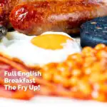 Close-up of sausages as part of full English fry up breakfast featuring a title overlay.