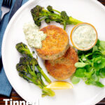 Overhead tinned mackerel fish cakes with homemade tartar sauce featuring a title overlay.