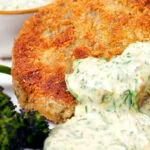 Close-up tinned mackerel fish cakes with homemade tartar sauce.