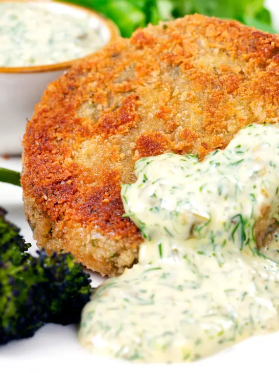 Close-up tinned mackerel fish cakes with homemade tartar sauce.