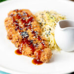 Japanese Tonkatsu pork cutlet served with katsu sauce and "soused" cabbage.
