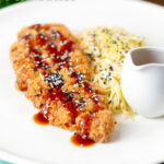 Japanese Tonkatsu pork cutlet served with katsu sauce and "soused" cabbage featuring a title overlay.