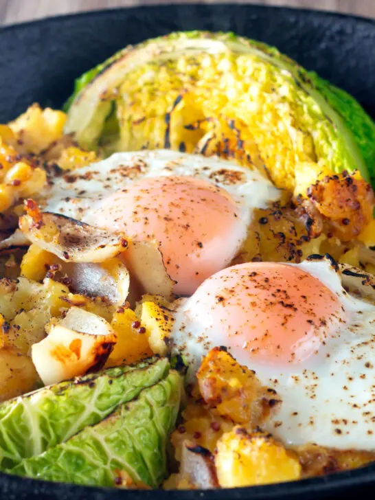 Close-up vegetarian cabbage and potato bake with eggs.