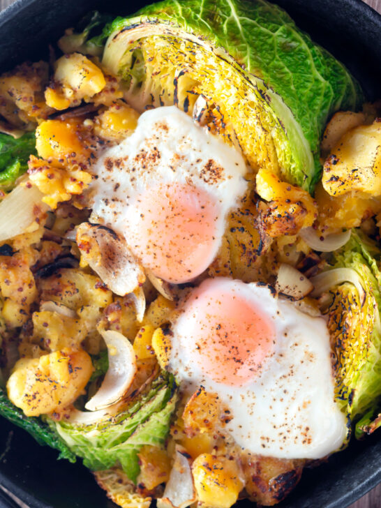 Overhead leftover cabbage and potato bake with eggs and mustard.