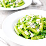 Two bowls of wild garlic pesto pasta with rigatoni.