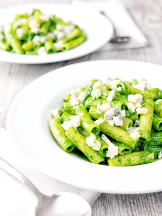 Two bowls of wild garlic pesto pasta with rigatoni.