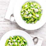 Overhead bowls of wild garlic pesto pasta with rigatoni.